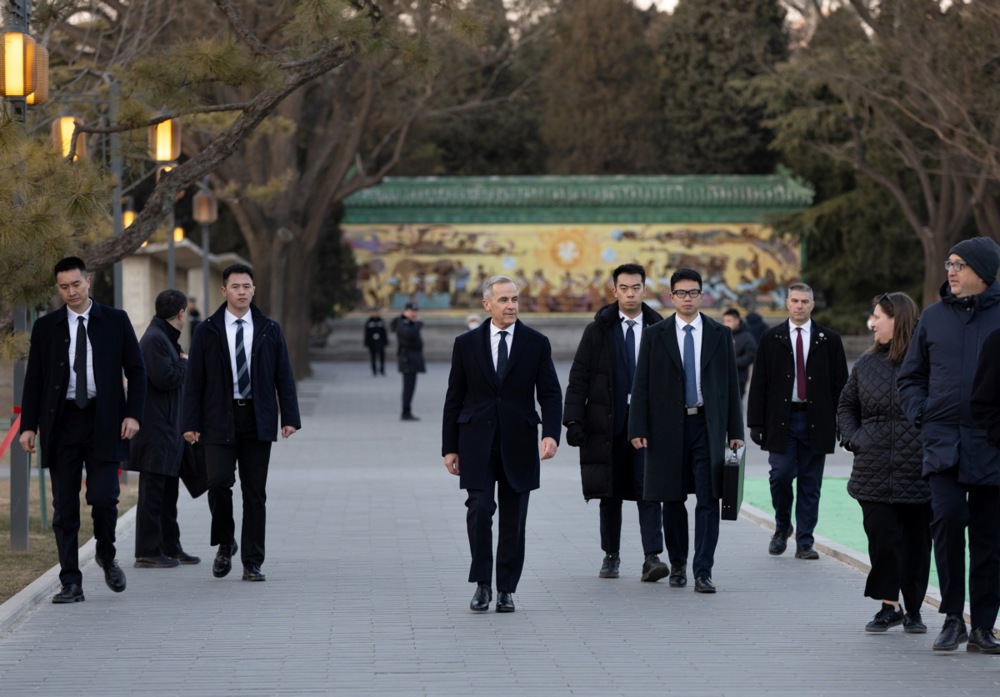 epa12652935 Canadian Prime Minister Mark Carney (C) leaves a press conference in Beijing, China, 16 January 2026. Carney is visiting Beijing from 14 to 17 January and met with Chinese President Xi Jinping earlier in the day. 