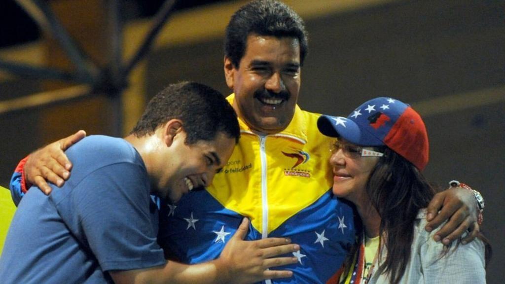 Ko je Silija Flores, nekada moćna prva dama Venecuele 6 Maduro grli svog sina - takođe Nikolasa - i suprugu, Siliju. Silija se osmehuje Nikolasu mlađem, koji tapše oca po grudima. Maduro stariji ima širok osmeh.