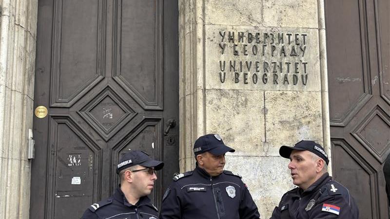 Smrt studentkinje Filozofskog fakulteta u Beogradu: Policija u Rektoratu, protesti ispred 2 Trojica policajaca stoje u uniformama ispred zgrade rektorata u Beogradu, iznad njih je natpis Univerzitet u Beogradu