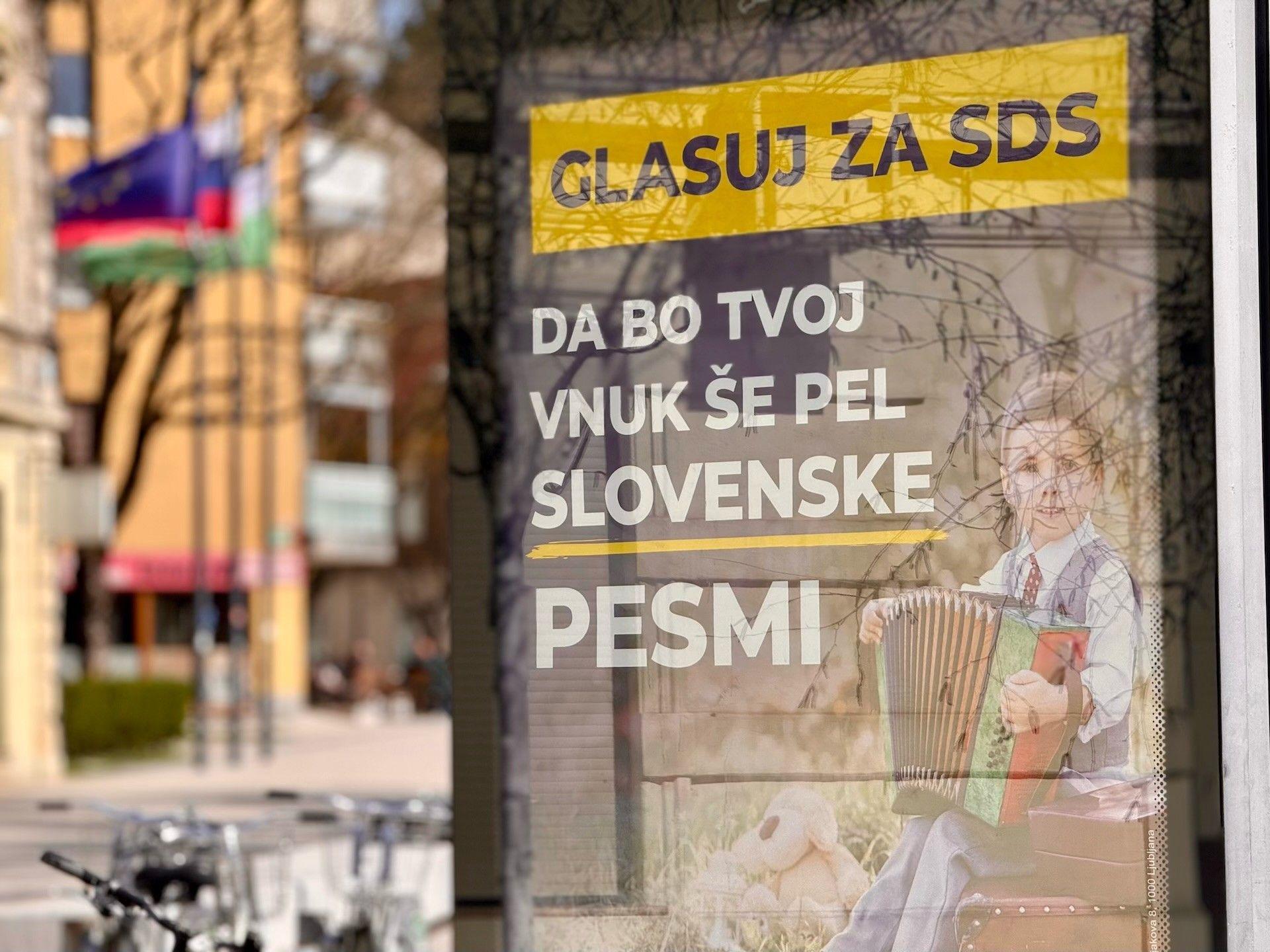 Izbori u Sloveniji: Kratak put od političkog punoletstva do 'najveće afere od osamostaljenja' 5 Dečak svira harmoniku na bilbordu SDSa