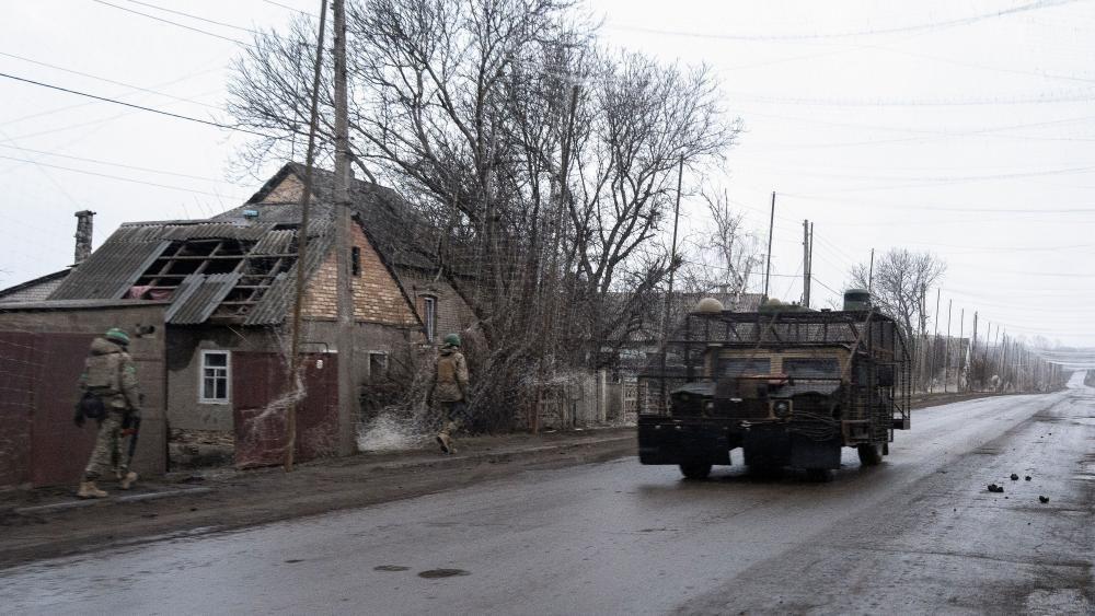 Mirovni pregovori u zastoju, Rusija tvrdi da je zauzela ceo Lugansk 4 Vozilo protiv dronova na putu i dva vojnika koji prolaze trotoarom pored razrušene kuće