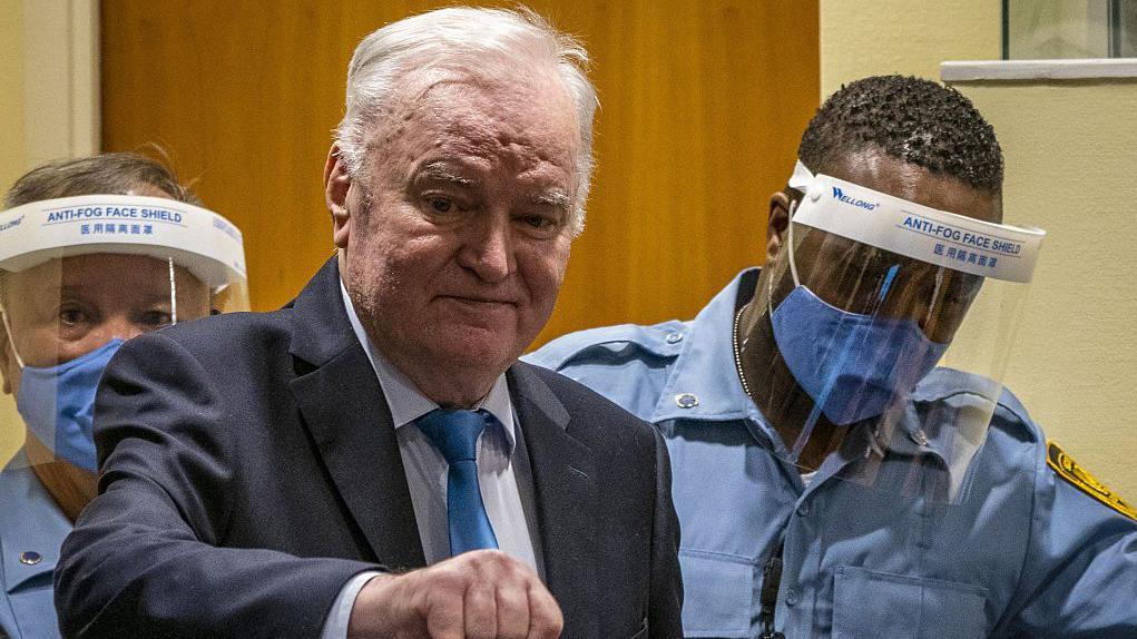 Ex-Bosnian Serb military chief Ratko Mladic arrives in the courtroom prior to the hearing of the final verdict on appeal against his genocide conviction over the 1995 Srebrenica massacre
